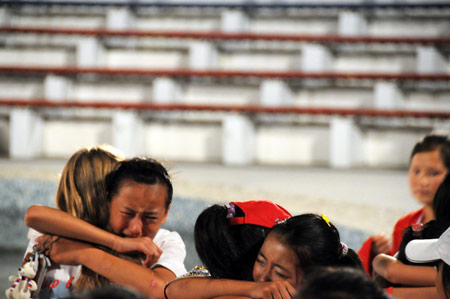 Chinese children hug their Russian counsellors at the 'Ocean' All-Russia Children's care center in Vladivostok, Russia, on August 11, 2009.