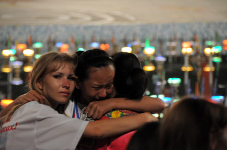 Chinese children hug their Russian counsellors at the &apos;Ocean&apos; All-Russia Children&apos;s care center in Vladivostok, Russia, on August 11, 2009.