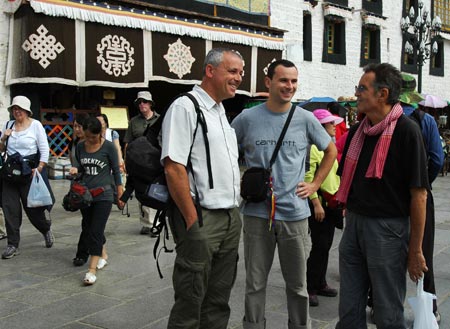 Foreign tourists go shopping on a street in Lhasa, capital of southwest China's Tibet Autonomous Region, on August 3, 2009.