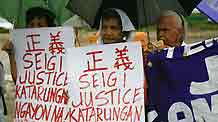 Filipino comfort women hold a demonstration outside the Japanese Embassy in Manila, capital of the Philippines, on August 12, 2009, demanding compensation and apologies from the Japanese government for the systematic rape of women by its imperial army during the Second World War.