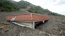 Photo taken on August 14, 2009 shows a house buried by debris flow in Kaohsiung, southeast China's Taiwan Province.