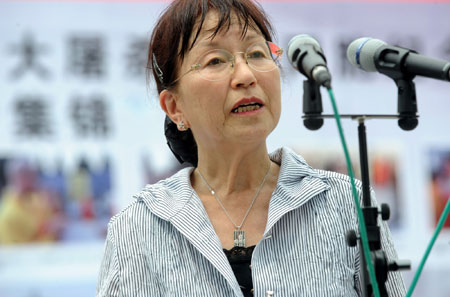 Matsuoka Tamaki,a primary school teacher from Osaka and head of Japanese left-wing group Mei Shin Kai delegation, addresses an assembly to commemorate the victims at the Memorial Hall of the Victims in Nanjing Massacre By Japanese Invaders in Nanjing, capital of east China's Jiangsu Province, on August 15, 2009.