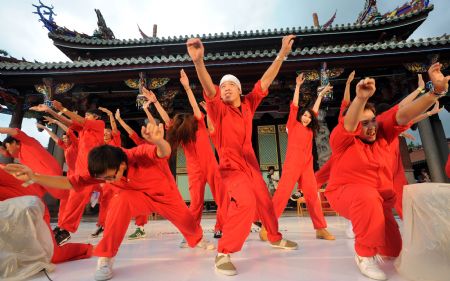 Members of the dance troupe Funk Crew dance in front of the Confucian Temple in Taipei of southeast China's Taiwan province, on August 16, 2009. A modern dancing show was held in Taipei on Sunday to collect money for victims of Typhoon Morakot in southern Taiwan.