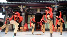 Members of the dance troupe Buzztop dance in front of the Confucian Temple in Taipei of southeast China's Taiwan province, on August 16, 2009.