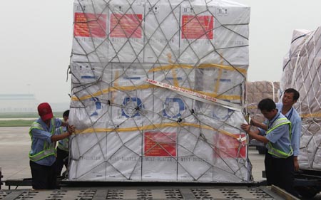 Working staff examine the relief supplies at the Beijing Capital International Airport, China, on August 18, 2009.