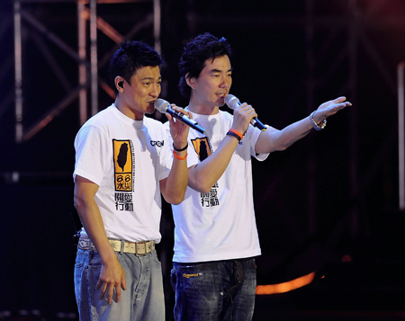 Actors Andy Lau (L) and Richie Ren Xian-Qi perform during a charity fundraising soiree in Hong Kong, China, on August 17, 2009.