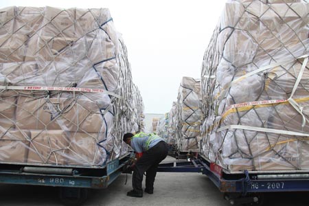 A working staff examines the relief supplies at the Beijing Capital International Airport, China, on August 18, 2009