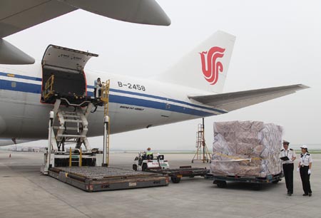 Staff of China Customs examine the relief supplies at the Beijing Capital International Airport, China, on August 18, 2009.