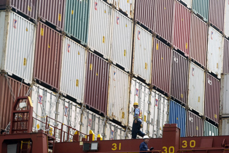 A cargo ship loaded with 100 makeshift houses in initial relief aid offered by mainland China docks at Kaohsiung port in southeast China's Taiwan Province, on August 18, 2009. The batch of the relief aid would be rushed to the Typhoon Morakot seriouly-striken areas in the island, which left more than 160 people dead and heavy property losses.