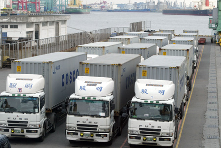 The container trucks loaded with 100 makeshift houses in initial relief aid offered by mainland China wait for departure at Kaohsiung port in southeast China's Taiwan Province, on August 18, 2009.