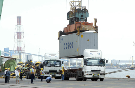 The container trucks loaded with 100 makeshift houses in initial relief aid offered by mainland China wait for departure at Kaohsiung port in southeast China's Taiwan Province, on August 18, 2009.