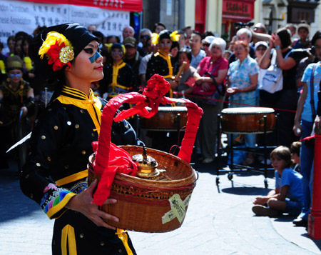  A member of an art troupe from Taiwan's Shih Chien University performs at a donation raising event for Taiwan's typhoon victims in Chinatown in London on August 18, 2009.