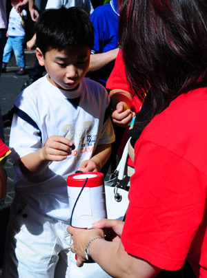 A little boy donates at a donation raising event for Taiwan's typhoon victims in Chinatown in London on August 18, 2009.