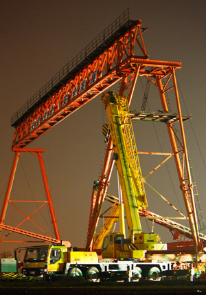 A construction vehicle is doing the clearing operations at the accident site after a 10-tonne gantry crane collapsed at a construction site of the Beijing-Shanghai High-speed Railway in Jiading District of Shanghai, east of China, on August 19, 2009. A total of four workers died and another two were injured at the accident.
