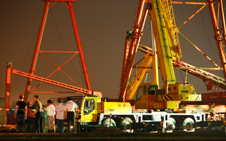 People from Safety Supervision Department survey at the accident site after a 10-tonne gantry crane collapsed at a construction site of the Beijing-Shanghai High-speed Railway in Jiading District of Shanghai, east of China, on August 19, 2009. A total of four workers died and another two were injured at the accident.
