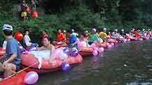 New couples float on Shanmu River in Shibing, southwest China's Guizhou Province, on August 18, 2009. Some 11 couples floated as a romantic wedding ceremony on Tuesday.