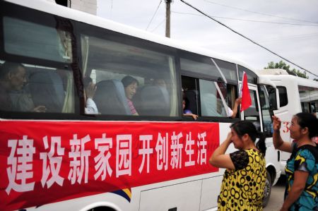 Residents of Guanmenyan Village in Danjiangkou City, central China's Hubei Province, leave their former residence here by bus for a new location on August 20, 2009. 