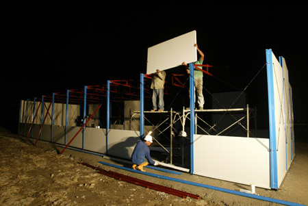Construction workers assemble the first shipment of prefab houses donated by mainland China for survivors of typhoon Moraket at Jiadong Township near Pingtung County in southeast China's Taiwan Province, on August 20, 2009.