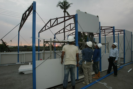 Construction workers assemble the first shipment of prefab houses donated by mainland China for survivors of typhoon Moraket at Jiadong Township near Pingtung County in southeast China's Taiwan Province, on August 20, 2009. 