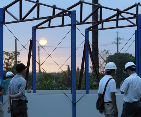 Construction workers assemble the first shipment of prefab houses donated by mainland China for survivors of typhoon Moraket at Jiadong Township near Pingtung County in southeast China's Taiwan Province, on August 20, 2009.