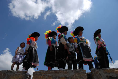 Local people of Miao ethnic group watch bull-fighting organized by villagers of Gaotang Township near Guiyang, capital city of southwest China's Guizhou Province, on August 22, 2009. 