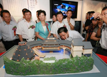 Guests visit model of the Guizhou pavilion for the 2010 Shanghai World Expo, in Shanghai, east China, on August 24, 2009. The promotion week of Guizhou of the Shanghai World Expo kicked off here on Monday.
