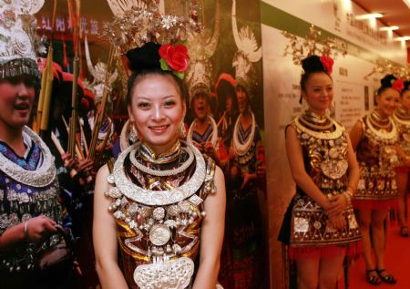 Girls of Miao ethnic group welcome guests during the Guizhou Promotion Week in Shanghai, east China, on August 24, 2009. The promotion week of Guizhou of the Shanghai World Expo kicked off here on Monday. 