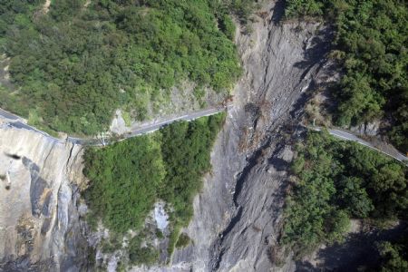 Photo taken on August 24, 2009 shows the severely-damaged Nanheng Road section across the Taoyuan Village of Kaohsiung County, southeast China's Taiwan.