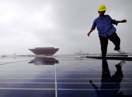 A worker walks on the solar power-generating panel roof of the Shanghai-Expo 2009 Theme Pavilion, the largest of its kind in single unit which was just finished for installation, in east China's Shanghai Municipality, Aug. 23, 2009. The solar power-generating panel extends to a total area of 30,000 square meters, accounting for a half of the 60,000-square-meters roof of the the Shanghai-Expo 2009 Theme Pavilion, with gross power output totaling 2.5 megawatts. 