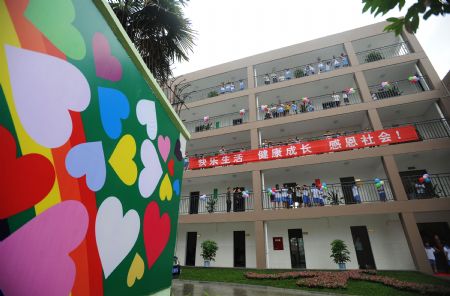 Photo taken on August 26, 2009 show a dormitory building of Xintanghu elementary school in Shuangliu, a county of southwest China's Sichuan Province. China has built the country's first special complex of new apartment buildings and schools for orphans and children of needy families in the quake-hit Sichuan Province.