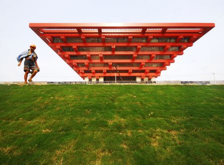 A worker walks down the grassland at the construction site of the World Expo Axis in Shanghai, east China, August 25, 2009. The landscaping of the World Expo Axis started recently.