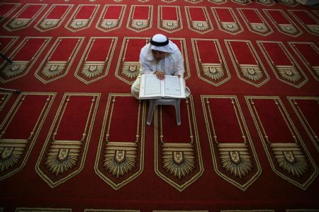 A Palestinian reads the Koran during the holy fasting month of Ramadan in Al-Omari mosque in Gaza City on August 26, 2009. 