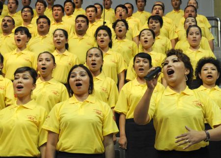 People perform a song named 'I love you, China' during a celebration to greet the coming 60th anniversary of the founding of the People Republic of China in Urumqi, capital of northwest China's Xinjiang Uygur Autonomous Region on August 27, 2009. 