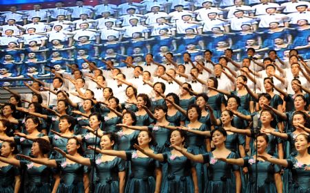 People perform during a celebration to greet the coming 60th anniversary of the founding of the People Republic of China in Urumqi, capital of northwest China's Xinjiang Uygur Autonomous Region on August 27, 2009.