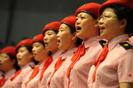 People sing patriotic song during a celebration to greet the coming 60th anniversary of the founding of the People Republic of China in Urumqi, capital of northwest China's Xinjiang Uygur Autonomous Region on August 27, 2009. 