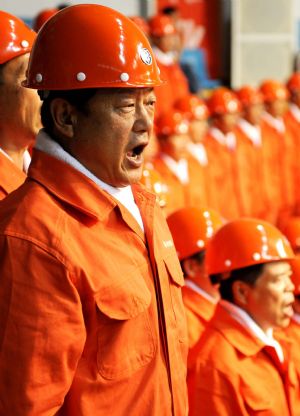 People sing patriotic song during a celebration to greet the coming 60th anniversary of the founding of the People Republic of China in Urumqi, capital of northwest China's Xinjiang Uygur Autonomous Region on August 27, 2009.