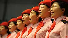 People sing patriotic song during a celebration to greet the coming 60th anniversary of the founding of the People Republic of China in Urumqi, capital of northwest China's Xinjiang Uygur Autonomous Region on August 27, 2009.