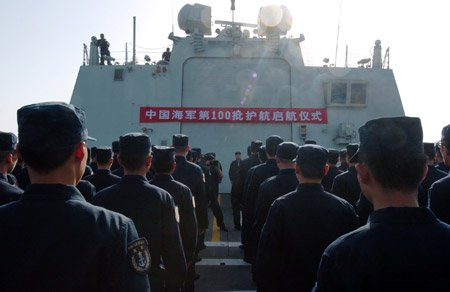 Chinese naval soldiers and officers of the Chinese escort flotilla attend the starting ceremony of the 100th escort mission on Zhoushan missile frigate in the eastern waters of the Gulf of Aden, Aug. 27, 2009. The Chinese naval task force started their 100th escort mission on Thursday in the eastern waters of the Gulf of Aden. (Xinhua/Guo Gang)