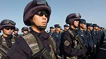 Chinese naval soldiers and officers of the Chinese escort flotilla attend the starting ceremony of the 100th escort mission on Zhoushan missile frigate in the eastern waters of the Gulf of Aden, August 27, 2009.