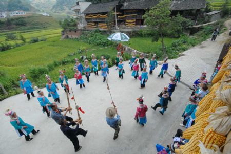 Villagers of the Miao ethnic group perform Lusheng dance to celebrate the Chixin Festival, or New Grain Tasting Festival, in a village of the Miao ethnic group in Duyu City of southwest China's Guizhou Province, August 28, 2009.