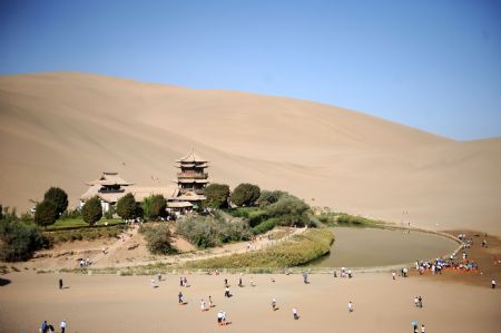 Tourists look around at Yueya Spring in Dunhuang, northwest China's Gansu Province, August 30, 2009.