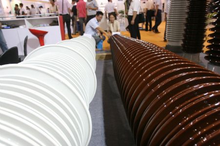An exhibitor introduces the porcelain insulator earmarked for high voltage power generating equipments, at the 3-day-long 2009 China International Pneumatic, Solar and Nuclear Power Industry, concurrently Electric Power and Electrician Equipment and Technology Exposition, which is held at the China International Exhibition Center, drawing some 800 enterprises from both China and overseas, at Beijing, September 2, 2009.