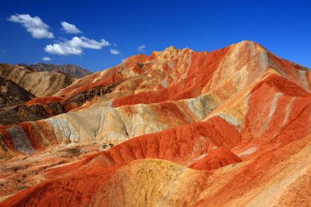 The file picture taken on July 26, 2009 shows the unique hilly terrain with red rocks and cliffs of the Danxia Landform in the mountainous areas of the Zhangye Geology Park near the city of Zhangye in northwest China's Gansu Province.