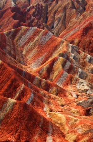 The file picture taken on July 26, 2009 shows the unique hilly terrain with red rocks and cliffs of the Danxia Landform in the mountainous areas of the Zhangye Geology Park near the city of Zhangye in northwest China's Gansu Province. 