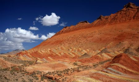 The file picture taken on July 26, 2009 shows the unique hilly terrain with red rocks and cliffs of the Danxia Landform in the mountainous areas of the Zhangye Geology Park near the city of Zhangye in northwest China's Gansu Province.