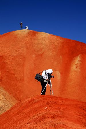 The file picture taken on July 26, 2009 shows the unique hilly terrain with red rocks and cliffs of the Danxia Landform in the mountainous areas of the Zhangye Geology Park near the city of Zhangye in northwest China's Gansu Province.