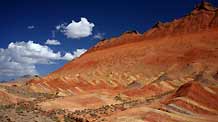 The file picture taken on July 26, 2009 shows the unique hilly terrain with red rocks and cliffs of the Danxia Landform in the mountainous areas of the Zhangye Geology Park near the city of Zhangye in northwest China's Gansu Province.