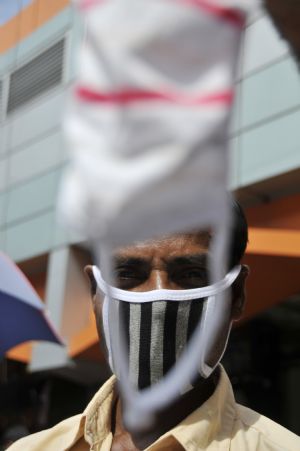 A street vendor displays a protective mask in Dhaka, capital of Bangladesh, September 3, 2009.