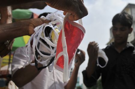 A street vendor sells masks in Dhaka, capital of Bangladesh, September 3, 2009.