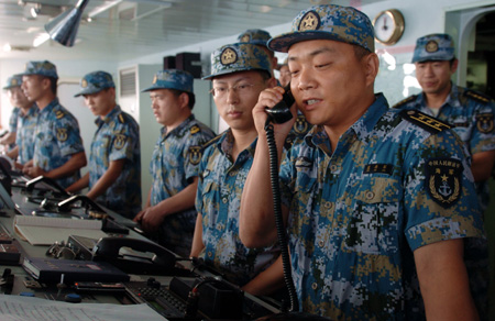 Captain of Chinese Navy&apos;s Zhoushan missile frigate Fan Zaijun (Front) talks with Captain of Russian Navy&apos;s Antisubmarine Warfare Ship &apos;Admiral Tributs&apos; via phone on the Gulf of Aden, on September 2, 2009.